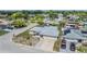 Aerial view of home featuring a new roof, solar panels, patio, and lush landscaping in a quiet neighborhood at 9115 Panda Ln, Port Richey, FL 34668