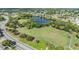 Beautiful aerial shot of a community park featuring a tranquil lake, walking path and lush landscaping at 9115 Panda Ln, Port Richey, FL 34668