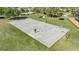 Aerial view of a park basketball court where a person is walking, with trees and green space nearby at 9115 Panda Ln, Port Richey, FL 34668