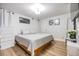 Cozy bedroom with laminate flooring, soft lighting, and light neutral decor at 9115 Panda Ln, Port Richey, FL 34668