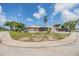 Charming corner-lot home featuring a pergola-covered patio and lush landscaping in a quiet neighborhood at 9115 Panda Ln, Port Richey, FL 34668
