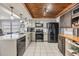 Modern kitchen with granite countertops, stainless steel appliances, and custom cabinets for a chef-inspired space at 9115 Panda Ln, Port Richey, FL 34668