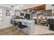 Kitchen with stainless appliances, island with bar stools, and plenty of storage space in the dark wood cabinets at 9115 Panda Ln, Port Richey, FL 34668