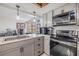 Bright eat-in kitchen featuring stainless steel appliances, tiled backsplash, sink with countertop accessories at 9115 Panda Ln, Port Richey, FL 34668