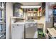 Functional laundry area with washer, dryer, water heater, and storage shelves, offering convenience and organization at 9115 Panda Ln, Port Richey, FL 34668