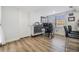 Laminate flooring in living area featuring a work-from-home office space near the eat-in kitchen at 9115 Panda Ln, Port Richey, FL 34668