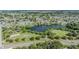 Aerial view of a residential community featuring a park and lake for outdoor activities and scenic beauty at 9115 Panda Ln, Port Richey, FL 34668