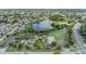 Overhead view of neighborhood park with lake, playground and basketball court surrounded by residential area at 9115 Panda Ln, Port Richey, FL 34668