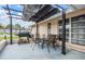 A relaxing patio with comfortable seating and a grill, perfect for outdoor gatherings and enjoying the weather at 9115 Panda Ln, Port Richey, FL 34668