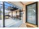 Cozy outdoor patio with an awning, grill, and seating for four, perfect for relaxation and entertaining at 9115 Panda Ln, Port Richey, FL 34668