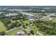 Expansive aerial view of the property showcasing its location near commercial areas and lush greenery at 9220 Mcintosh Rd, Dover, FL 33527