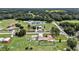 Property aerial shot featuring a well-maintained yard, and serene surroundings with lush green trees at 9220 Mcintosh Rd, Dover, FL 33527