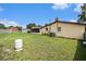 Spacious backyard featuring lush green grass and a screened porch with plenty of space for outdoor activities at 9220 Mcintosh Rd, Dover, FL 33527
