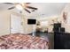 Bedroom features a ceiling fan, hardwood floors and a walk-in closet at 9220 Mcintosh Rd, Dover, FL 33527