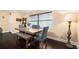 Dining area featuring a wooden table with bench seating, hardwood floors, and a cozy atmosphere at 9220 Mcintosh Rd, Dover, FL 33527