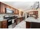 Modern kitchen features stainless steel appliances, tile backsplash, and granite counters at 9220 Mcintosh Rd, Dover, FL 33527