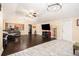 Living room featuring vaulted ceilings, stylish light fixtures, and hardwood floors at 9220 Mcintosh Rd, Dover, FL 33527