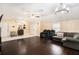 Bright living room featuring vaulted ceilings, modern light fixtures, and hardwood floors at 9220 Mcintosh Rd, Dover, FL 33527