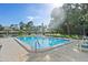 Large community pool with lounge chairs for relaxing and enjoying the sun at 9737 86Th Ave, Seminole, FL 33777