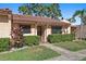 Inviting front exterior of a home featuring a well-maintained yard and a charming tile roof at 9737 86Th Ave, Seminole, FL 33777