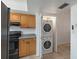 Efficient kitchen with appliances and adjacent closet with stackable washer and dryer at 9737 86Th Ave, Seminole, FL 33777
