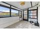 Sunroom with tile flooring, windows, and a door providing views and access to the outside at 9737 86Th Ave, Seminole, FL 33777