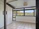 Enclosed sunroom with tile flooring, white walls, and large windows providing natural light at 9737 86Th Ave, Seminole, FL 33777