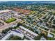Expansive aerial view showcasing a vibrant community near shopping centers and lush green spaces at 9945 47Th N Ave # 210, St Petersburg, FL 33708
