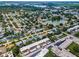 Aerial view of a residential neighborhood with mature trees, a small lake, and well-maintained homes at 9945 47Th N Ave # 210, St Petersburg, FL 33708