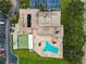 A bird's eye view shows the layout with a pool, shuffleboard court, parking, and lush landscaping at 9945 47Th N Ave # 210, St Petersburg, FL 33708