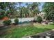 Fenced backyard with well-manicured lawn, patio area and comfortable seating provides an outdoor sanctuary at 9945 47Th N Ave # 210, St Petersburg, FL 33708