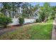 Backyard with a large lawn, privacy fence, mature trees and outdoor seating at 9945 47Th N Ave # 210, St Petersburg, FL 33708