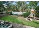 Spacious backyard featuring a well-maintained lawn, patio seating and beautiful landscaping at 9945 47Th N Ave # 210, St Petersburg, FL 33708