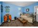 Spare bedroom features drum set, daybed, and blue walls at 9945 47Th N Ave # 210, St Petersburg, FL 33708