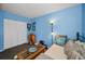 Spare bedroom features drum set, daybed, and blue walls and closet at 9945 47Th N Ave # 210, St Petersburg, FL 33708