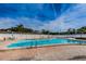 A pristine community pool with ample seating and clear blue water invites residents to relax and enjoy the outdoors at 9945 47Th N Ave # 210, St Petersburg, FL 33708