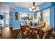 Charming dining room features seating for four, bright blue accent walls and wood-style flooring at 9945 47Th N Ave # 210, St Petersburg, FL 33708