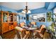 Charming dining room features seating for four, bright blue accent walls and wood-style flooring at 9945 47Th N Ave # 210, St Petersburg, FL 33708