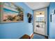 Condo entryway with blue accent wall and a beach painting at 9945 47Th N Ave # 210, St Petersburg, FL 33708