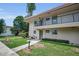 Cozy condo featuring a welcoming entrance, well-maintained lawn, and inviting outdoor seating at 9945 47Th N Ave # 210, St Petersburg, FL 33708