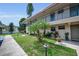 Charming two-story condo with a cozy patio and manicured lawn under a bright sky at 9945 47Th N Ave # 210, St Petersburg, FL 33708