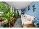 Open sunroom with tile floors, white trim, plants and seating provides lots of natural light at 9945 47Th N Ave # 210, St Petersburg, FL 33708