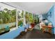Open sunroom with tile floors, white trim, large windows and seating provides lots of natural light at 9945 47Th N Ave # 210, St Petersburg, FL 33708