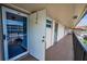 View of a common hallway, featuring multiple condo doors and metal railing at 9945 47Th N Ave # 210, St Petersburg, FL 33708