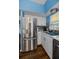 Well-lit kitchen features stainless steel appliances, marble countertops and wood-style flooring at 9945 47Th N Ave # 210, St Petersburg, FL 33708