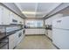 A well-equipped kitchen featuring white appliances and ample counter space at 9945 47Th N Ave # 210, St Petersburg, FL 33708
