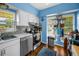 Bright kitchen area showcasing modern appliances, white cabinets and updated backsplash at 9945 47Th N Ave # 210, St Petersburg, FL 33708