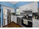 Well-lit kitchen featuring stainless steel appliances, sleek backsplash, and wood-style flooring at 9945 47Th N Ave # 210, St Petersburg, FL 33708
