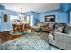 Living room and dining area with blue walls, complemented by hardwood floors and an area rug at 9945 47Th N Ave # 210, St Petersburg, FL 33708