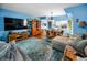 Bright living room and dining area with blue walls, hardwood floors and an area rug at 9945 47Th N Ave # 210, St Petersburg, FL 33708